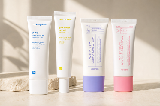 Four Korean sunscreens from Face Republic and #OOTD arranged in warm morning light on an ivory surface.