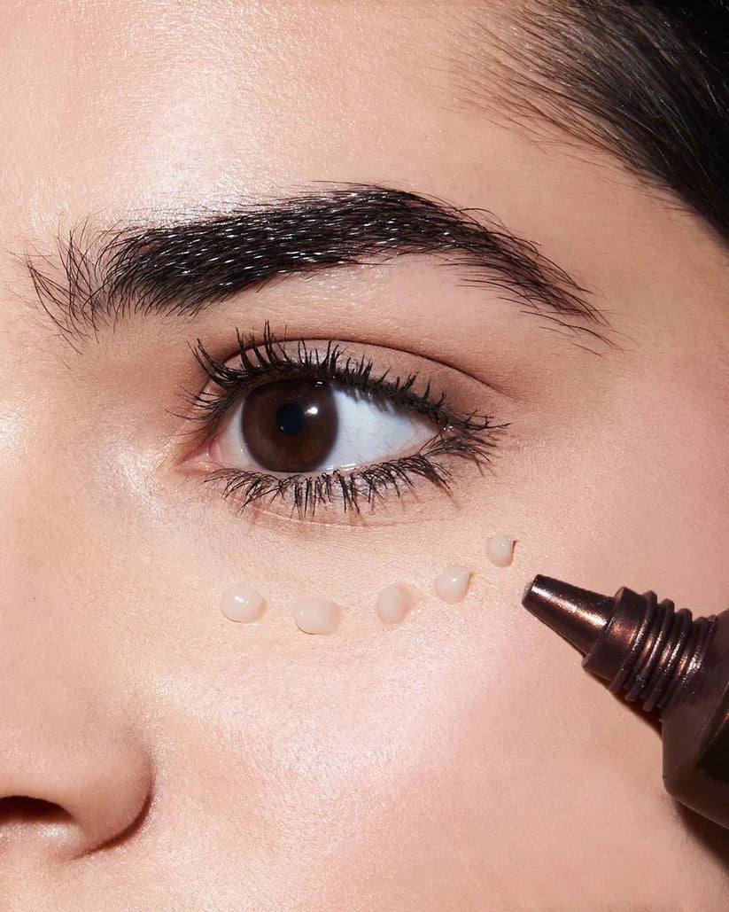 ACWELL eye cream applied beneath the eye with the tube visible
