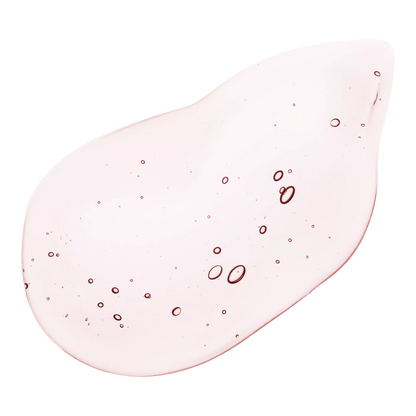 Close-up of a pale pink ANUA Peach serum swatch with small bubbles.