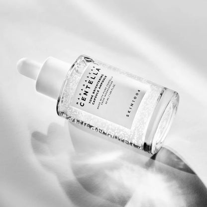 SKIN1004 Tone Brightening Capsule Ampoule 50ml bottle lying in bright light with a soft shadow.