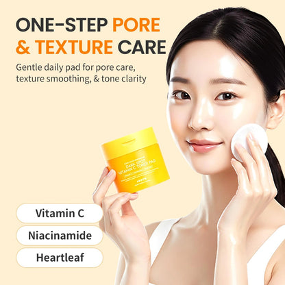 Model applying #OOTD Dark Spot Vitamin C Toner Pad to the cheek beside the jar with vitamin C, niacinamide, and heartleaf callouts.