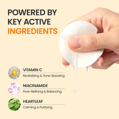 Hand squeezing a wet #OOTD Dark Spot Vitamin C Toner Pad with vitamin C, niacinamide, and heartleaf ingredient callouts.