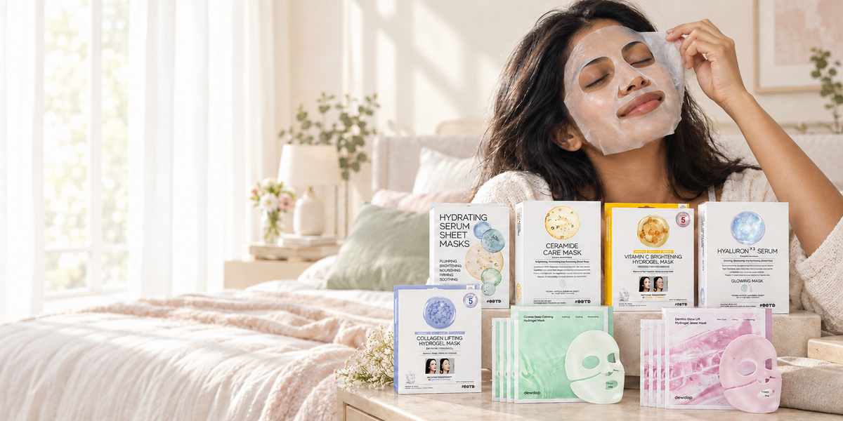 Woman wearing a sheet mask beside an assortment of Korean sheet masks in a bright bedroom.